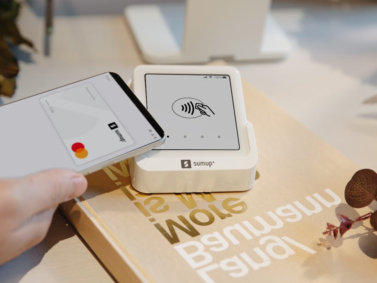 A phone making a contactless card payment on a card reader